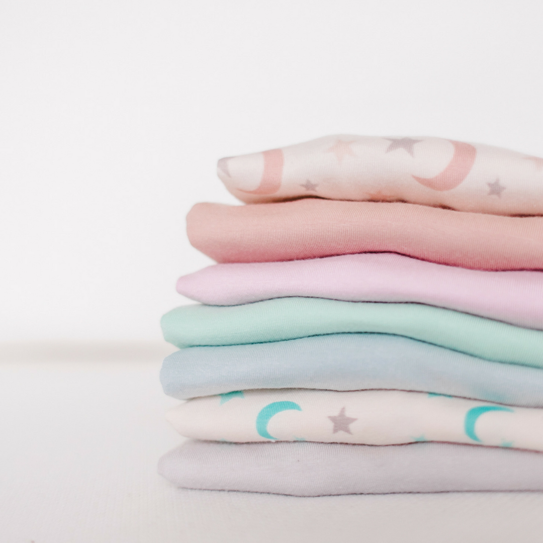 stack of westyn baby pajamas